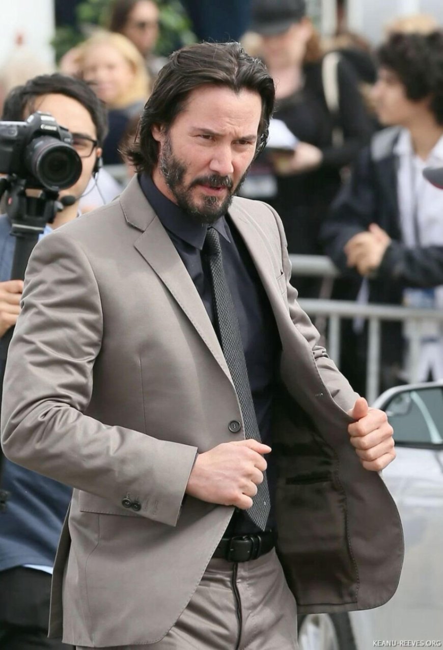 Keanu Reeves reageert verheugd op het zien van zijn vriendin Alexandra Grant op de rode loper